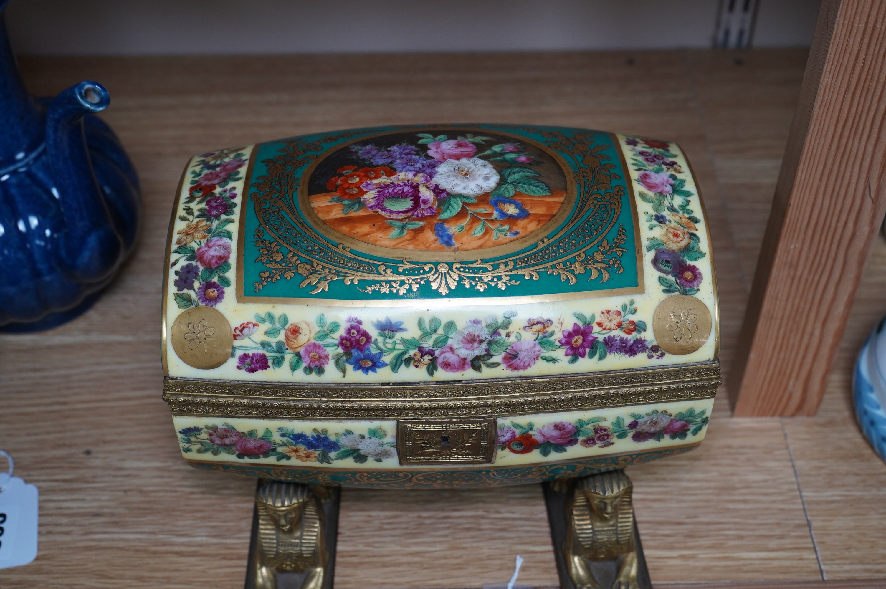 An early 20th century Sevres style sarcophagus shaped casket, on twin sphinx ormolu base, 24cm. Condition - good